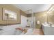 Bright bathroom featuring a soaking tub, glass-enclosed shower, and double vanity at 1735 Peachtree Ne St # 316, Atlanta, GA 30309
