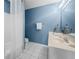 Stylish blue bathroom featuring vanity with decorative accents and tub with shower at 1735 Peachtree Ne St # 316, Atlanta, GA 30309