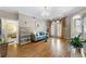A well-lit living room with hard wood flooring with doors leading to a patio at 1735 Peachtree Ne St # 316, Atlanta, GA 30309