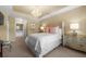 A bright main bedroom with a white bedspread, chandelier, and ensuite bathroom at 1735 Peachtree Ne St # 316, Atlanta, GA 30309
