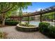 Beautifully landscaped pool area with pergola, brick pavers, and lush greenery at 1735 Peachtree Ne St # 316, Atlanta, GA 30309