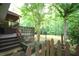 Wooden deck and steps leading to a private backyard surrounded by mature trees at 188 Thornbrooke Dr, Hiram, GA 30141