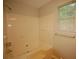 Bathroom featuring shower and tub combination with safety hand rails and a window providing natural light at 188 Thornbrooke Dr, Hiram, GA 30141
