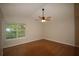 Airy bedroom with wood floors, fan, and natural light streaming through the window at 188 Thornbrooke Dr, Hiram, GA 30141