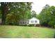 Charming home featuring a well-manicured lawn and beautiful landscaping, surrounded by lush greenery at 188 Thornbrooke Dr, Hiram, GA 30141