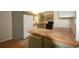 Charming kitchen featuring olive green cabinets, tile countertops, and laminate flooring at 188 Thornbrooke Dr, Hiram, GA 30141