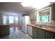 Kitchen showcasing olive green cabinets, stainless steel sink, and breakfast bar at 188 Thornbrooke Dr, Hiram, GA 30141
