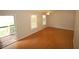 Open concept living room featuring hardwood floors, neutral walls, and a sliding glass door that leads to a deck at 188 Thornbrooke Dr, Hiram, GA 30141