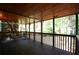 Well-lit screened porch features wooden floor, ceiling, and handrails, providing a cozy outdoor space at 188 Thornbrooke Dr, Hiram, GA 30141