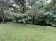 Expansive backyard with green lawn and mature trees; idyllic for outdoor activities and serene relaxation at 2529 Feathertree Ln, Lawrenceville, GA 30044