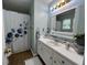 Bright bathroom with a large mirror and white vanity, providing a clean and modern aesthetic at 2529 Feathertree Ln, Lawrenceville, GA 30044