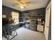 Functional bedroom with ceiling fan, featuring a workspace and storage shelves for organization at 2529 Feathertree Ln, Lawrenceville, GA 30044