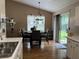 Open dining space with a view of the kitchen, and backyard at 2529 Feathertree Ln, Lawrenceville, GA 30044