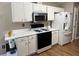 Clean, all white kitchen with stainless steel appliances and modern fixtures at 2529 Feathertree Ln, Lawrenceville, GA 30044