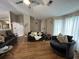 Bright living room featuring high ceilings, comfortable seating, and hardwood flooring at 2529 Feathertree Ln, Lawrenceville, GA 30044