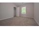 Neutral bedroom with plush carpeting, closet, and natural light from a window at 488 Charleston Pl, Villa Rica, GA 30180