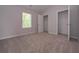 Neutral bedroom with plush carpeting, closet, and natural light from a window at 488 Charleston Pl, Villa Rica, GA 30180