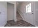 Inviting entryway featuring wood-look floors, staircase, and closet for convenient storage at 488 Charleston Pl, Villa Rica, GA 30180