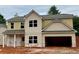 New two-story home featuring neutral siding, a two-car garage, and a covered front porch at 488 Charleston Pl, Villa Rica, GA 30180