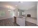 Open kitchen features an island, wood floors, and a fireplace in the adjoining living space at 488 Charleston Pl, Villa Rica, GA 30180