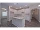 Bright kitchen featuring granite island, white cabinets, and an open layout for entertaining at 488 Charleston Pl, Villa Rica, GA 30180