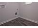 Bright laundry room with wood grain flooring and gray walls, ready for your appliances at 488 Charleston Pl, Villa Rica, GA 30180
