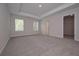 Large main bedroom suite featuring trey ceilings, carpeted floors, two windows, and walk-in closet at 488 Charleston Pl, Villa Rica, GA 30180