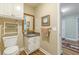 Powder room features granite countertop vanity, decorative mirror, and a nearby toilet at 9707 Squirrel Wood Run, Douglasville, GA 30135