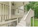 Wooden staircase leads to a spacious deck with railings, offering an inviting outdoor space at 9707 Squirrel Wood Run, Douglasville, GA 30135
