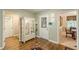 Open foyer showcasing hardwood floors, glass front door, and access to various rooms at 9707 Squirrel Wood Run, Douglasville, GA 30135