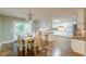 Eat-in kitchen includes a dining table, hardwood floors, island with chairs, and access to the deck at 9707 Squirrel Wood Run, Douglasville, GA 30135