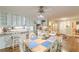 View of the eat-in kitchen featuring hardwood floors, white cabinets, and open access to the kitchen at 9707 Squirrel Wood Run, Douglasville, GA 30135