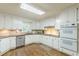 Bright kitchen featuring white cabinets, hardwood floors, stainless steel appliances, and tile backsplash at 9707 Squirrel Wood Run, Douglasville, GA 30135