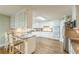 The kitchen features an eat-in island, tile backsplash, stainless steel appliances, and hardwood floors at 9707 Squirrel Wood Run, Douglasville, GA 30135