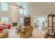 Bright and airy living room with fireplace and tall windows with backyard views at 9707 Squirrel Wood Run, Douglasville, GA 30135