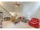 Spacious living room with a high ceiling, ceiling fan, carpet and a staircase visible in the back at 9707 Squirrel Wood Run, Douglasville, GA 30135