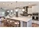 Bright, modern kitchen features a large island with seating, stainless steel appliances, and hardwood flooring at 1047 Brandsford Nw St, Atlanta, GA 30318