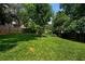 Large, well-maintained backyard with lush green grass and mature trees, providing privacy at 1558 Line St, Decatur, GA 30032