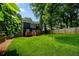 Expansive backyard with a large tree, privacy fence, and lush green grass at 1558 Line St, Decatur, GA 30032