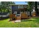 A deck with a built in bar area overlooks the large grassy back yard with a privacy fence at 1558 Line St, Decatur, GA 30032