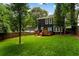Large, well-manicured backyard with a dark two-story home and fenced perimeter at 1558 Line St, Decatur, GA 30032