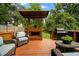 Backyard deck features an outdoor kitchen area, fireplace, grill, and comfortable seating at 1558 Line St, Decatur, GA 30032