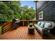 Backyard deck features an outdoor kitchen area, grill, and comfortable seating with pillows at 1558 Line St, Decatur, GA 30032