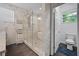 Bright bathroom featuring a glass shower with a soaking tub and marble tile walls at 1558 Line St, Decatur, GA 30032