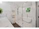 Bright bathroom featuring a soaking tub inside a glass enclosure and marble walls at 1558 Line St, Decatur, GA 30032