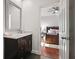 Bathroom view through doorway to a bedroom with a dark vanity and modern finishes at 1558 Line St, Decatur, GA 30032