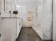 Bright bathroom with white cabinets, marble countertop, and glass shower enclosure at 1558 Line St, Decatur, GA 30032