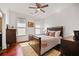 Bedroom with wood floors, ceiling fan, bedside tables and bright, sunny windows at 1558 Line St, Decatur, GA 30032