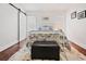 Cozy bedroom features a metal frame bed, barn door, wood floors and a plush area rug at 1558 Line St, Decatur, GA 30032