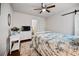 This bedroom features wood floors, ceiling fan, white dresser and barn door access at 1558 Line St, Decatur, GA 30032